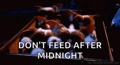 Two Gremlins Sitting In Theater Watching Movie One Holding Chips GIF