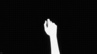 Two Hands Holding Each Other In The Dark GIF