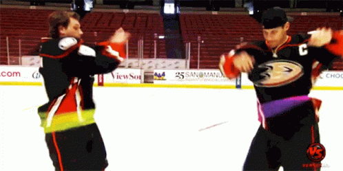 Two Hockey Players Are Dancing On The Ice And One Has The Letter C On Their Jersey GIF