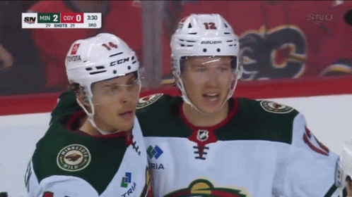 Two Hockey Players Are On The Ice And One Has The Number 14 On His Helmet GIF