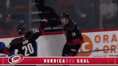 Two Hockey Players Celebrate A Hurricanes Goal In Front Of A Gatorade Ad GIF