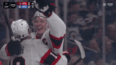 Two Hockey Players Celebrating 2-2 Goal GIF