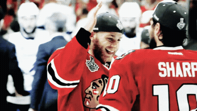 Two Hockey Players High Five Each Other With One Wearing The Number 10 And The Other Wearing The Number 16 GIF
