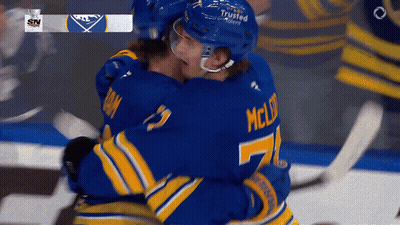 Two Hockey Players Hugging Number 7 Jersey GIF