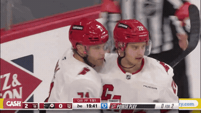 Two Hockey Players Hugging Scoreboard Cash GIF
