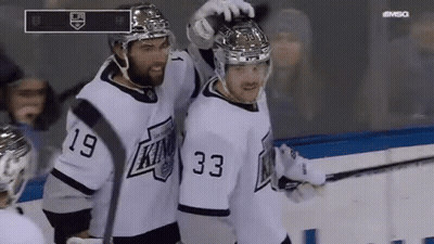 Two Hockey Players In White Jerseys Number 33 GIF