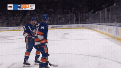 Two Hockey Players On The Ice With A Scoreboard That Says Sn On It GIF