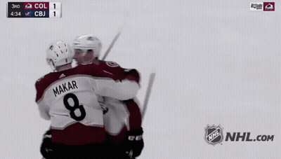 Two Hockey Players Shaking Hands In Front Of A Nhl Logo GIF