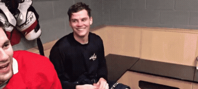 Two Hockey Players Smiling In Locker Room GIF