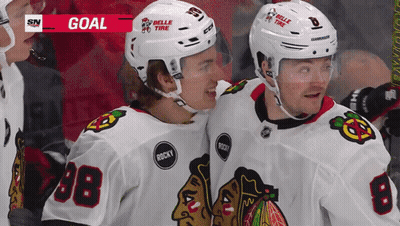 Two Hockey Players Wearing Belle Tire Helmets GIF