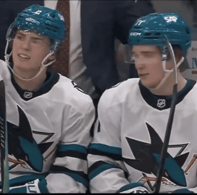 Two Hockey Players Wearing Ccm Helmets Sit On The Bench GIF