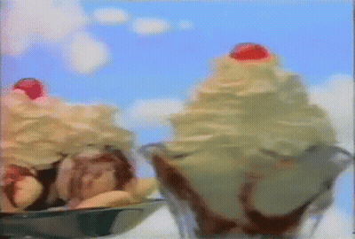 Two Ice Cream Sundaes With Whipped Cream And Cherry On Top GIF