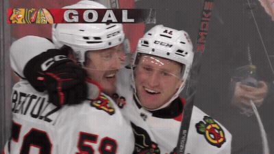 Two Ice Hockey Players Celebrate Goal GIF