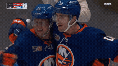 Two Ice Hockey Players Hugging In Front Of Scoreboard 1St WSH 0 NY 1 GIF