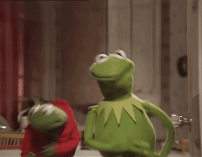 Two Kermit The Frogs Are Standing Next To Each Other And One Is Wearing A Red Sweater GIF