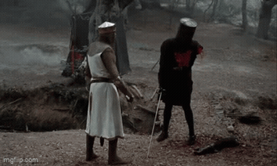 Two Knights In Woods One Holding Sword GIF