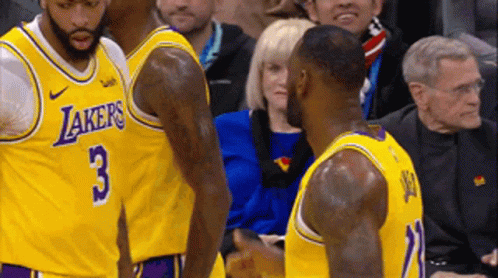 Two Lakers Basketball Players Are Talking To Each Other During A Game GIF