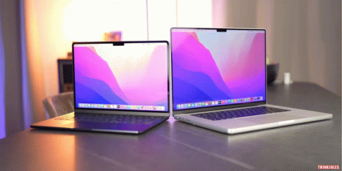 Two Laptops Are Sitting On A Table And One Of Them Says Thinkfiles GIF