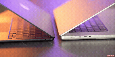 Two Laptops Are Sitting Side By Side And One Has The Word Thinkfiles On The Bottom GIF