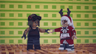 Two Lego Figures Are Standing Next To Each Other And One Is Wearing A Reindeer Hat GIF