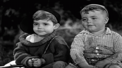 Two Little Boys Sitting Next To Each Other One Wearing Hat GIF