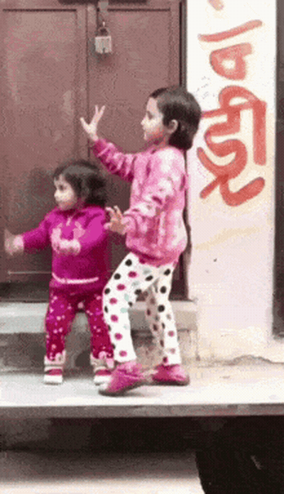 Two Little Girls Dancing In Front Of Graffiti Wall GIF