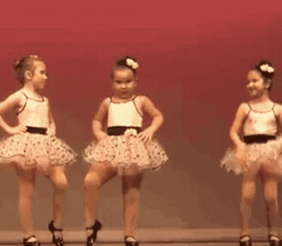 Two Little Girls Dancing In Tutus On Stage GIF