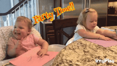 Two Little Girls Sitting At Table Saying Party Time GIF