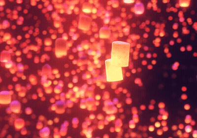Two Marshmallows Floating In Red And Pink Lights GIF