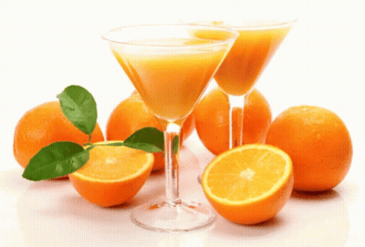 Two Martini Glasses Filled With Orange Juice Next To Oranges GIF