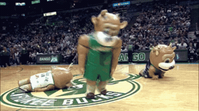 Two Mascots On A Basketball Court With The Word Bucks On The Floor GIF