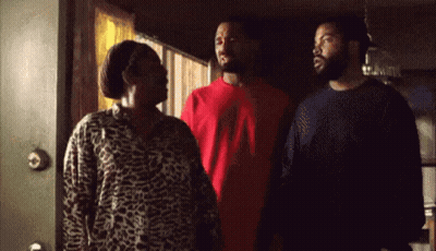 Two Men And A Woman Standing At Door GIF