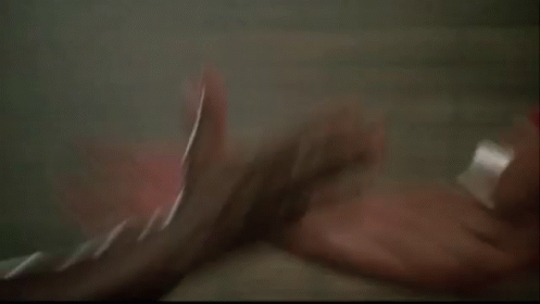 Two Men Are Arm Wrestling Each Other In A Gym . GIF