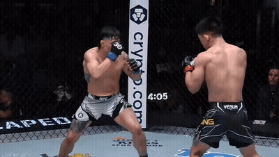 Two Men Are Boxing In A Ring With A Sign That Says Crypto.com On It GIF