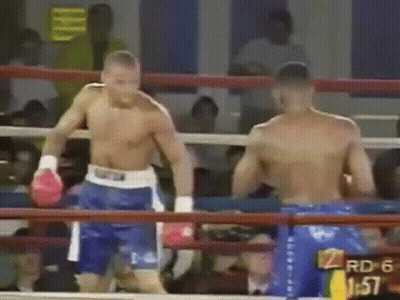Two Men Are Boxing In A Ring With A Sign That Says Rd 6 1:57 GIF