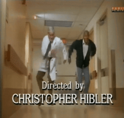 Two Men Are Dancing In A Hallway With A Sign On The Wall That Says Family GIF