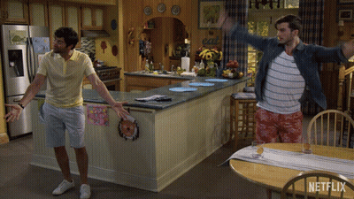 Two Men Are Dancing In A Kitchen With A Sign That Says Eat GIF