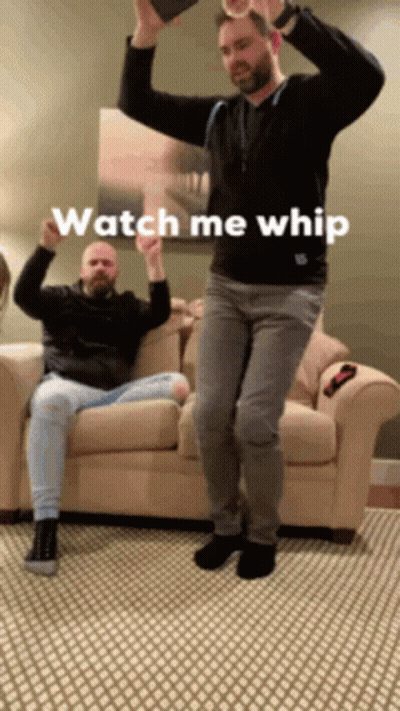 Two Men Are Dancing In A Living Room With The Words Watch Me Whip Written On The Bottom GIF
