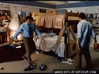 Two Men Are Dancing In A Messy Bedroom With A Bunk Bed In The Background GIF