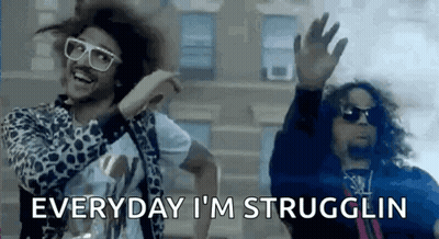 Two Men Are Dancing In Front Of A Building And One Of Them Is Wearing Sunglasses And A Leopard Print Jacket . GIF