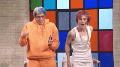 Two Men Are Dancing In Front Of A Colorful Window . GIF
