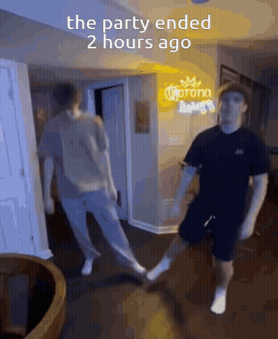 Two Men Are Dancing In Front Of A Sign That Says Corona GIF