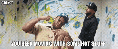 Two Men Are Dancing In Front Of A Wall With The Words You Been Moving With Some Hot Stuff GIF