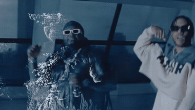 Two Men Are Dancing In Front Of A Window And One Has A Hoodie That Says Amir On It GIF
