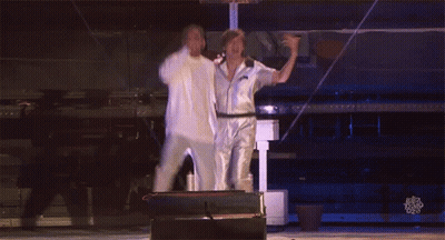 Two Men Are Dancing On A Stage And The Words Ellen Degeneres Are Visible In The Corner GIF