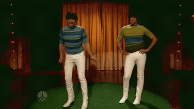 Two Men Are Dancing On A Stage With The Nbc Logo In The Background . GIF