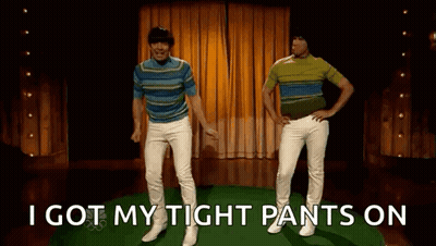Two Men Are Dancing On A Stage With The Words `` I Got My Tight Pants On '' Behind Them . GIF