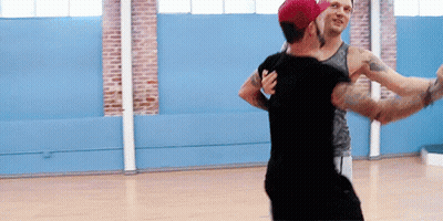Two Men Are Dancing Together In A Dance Studio GIF