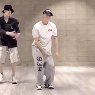 Two Men Are Dancing Together In A Room . GIF