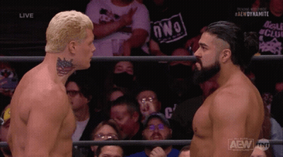 Two Men Are Facing Each Other In A Wrestling Ring With A Crowd Behind Them And The Words Aew Dynamite On The Bottom GIF